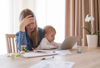 Mom working with baby on lap
